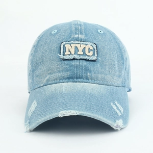 Close-up of the NYC 3D letter embroidery on this light blue washed denim baseball cap