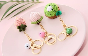 Handmade crochet fruit keychains with strawberry peach kiwi shapes and gold bells