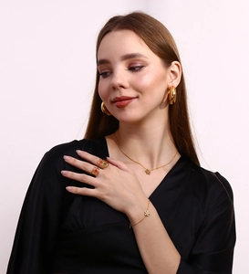 Close-up of a model wearing 18K gold-plated flower pendant jewelry set with earrings