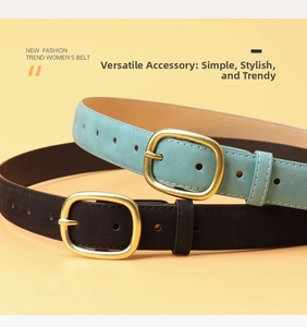 Detail of suede leather belts in blue and black with gold oval buckles and white stitching