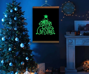Luminous Merry Christmas wall scroll with glow-in-the-dark lettering in dark setting