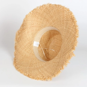 Detail of 100% raffia straw hat with frayed brim and internal adjustable sweatband