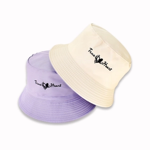 Close-up of embroidered True Heart lettering on reversible cotton bucket hats