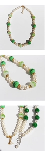 Detail of pink and green glass bead necklaces with white pearls and lobster clasps