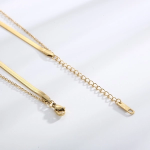 Detail of double-layer gold snake chain necklace with lobster clasp and extension