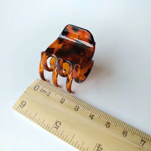 Detailed view of 3.5cm tortoiseshell hair claw clip with measuring ruler on white background