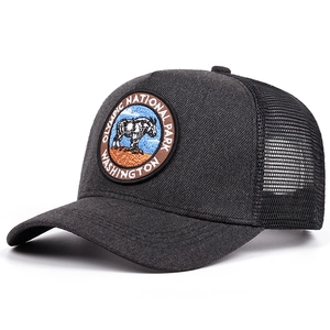 Vintage Olympic National Park black trucker hat with mountain goat embroidery at 45 degree angle