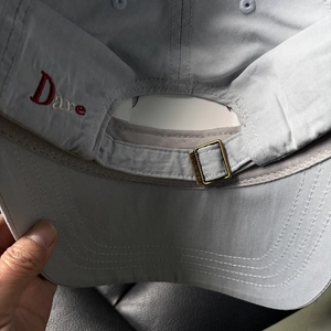 Back view of light blue washed cotton baseball cap with red Dare embroidery and metal buckle