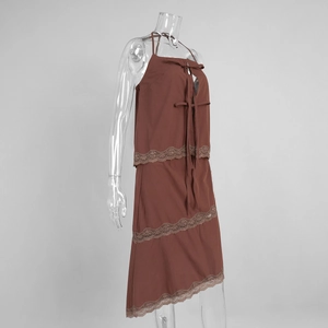 Detail of brown halter neck dress with delicate lace trim and ribbon bow accents