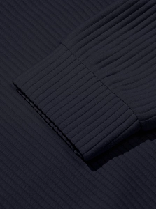Detailed close-up of navy blue ribbed knit cuffs on a men's corduroy sweatshirt