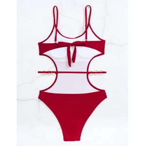 Detail of red one-piece swimsuit with cutout waist, metal chain links and back tie