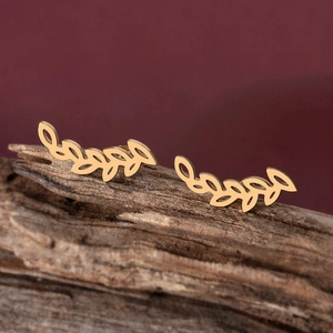 Elegant gold-plated leaf ear climbers with hollow filigree design on wood base