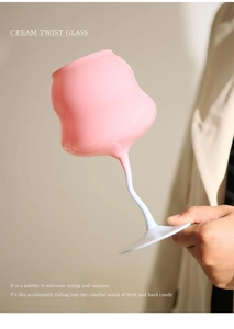 Detail of a pink and white cream twist wine glass with a unique wavy stem design