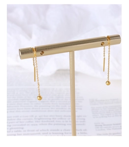 Detailed view of 18K gold plated stainless steel threader earrings on a jewelry stand