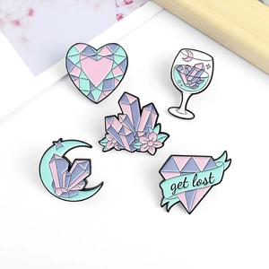 Set of five macaron-colored enamel pins featuring crystal hearts and moon shapes