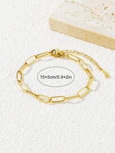 Detailed view of golden stainless steel paperclip bracelet with size tags and lobster clasp