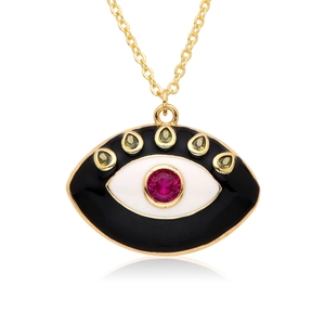 Macro detail of Evil Eye pendant with green teardrop stones and red center gemstone
