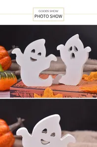 Detail of wooden ghost ornaments with cute facial expressions for Halloween tray decor