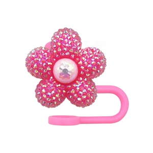 Detailed view of pink flower straw cap with sparkling rhinestones and center pearl inlay