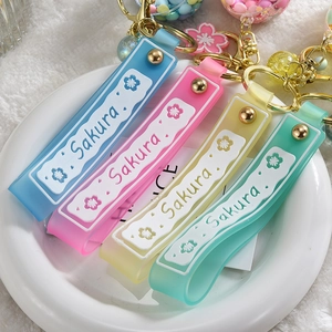 Detail of colorful Sakura lollipop keychains in blue, pink, yellow and mint green hues