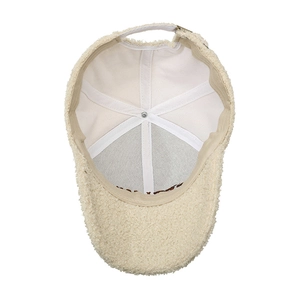 Inside view of beige teddy fleece baseball cap with canvas lining and adjustable strap