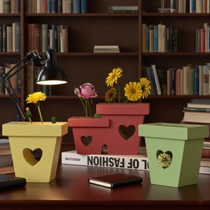 Detailed view of heart-shaped hollowed planters with matte finish for home desktop decoration