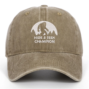 Detailed white embroidery of Hide & Seek Champion bigfoot on washed brown baseball cap