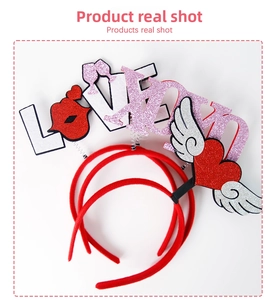 Detail of party headband featuring glittery LOVE letters and red heart wing motifs