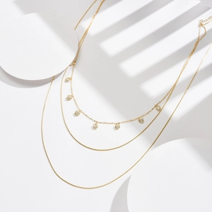Three-layer gold s925 silver necklace with delicate heart charms and pearl accents
