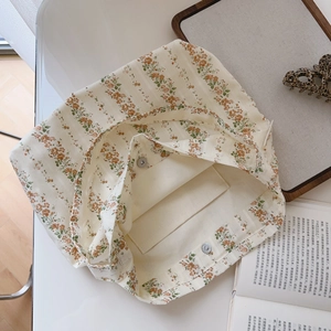 Detail view of the floral cotton bag showing the magnetic closure and internal pocket