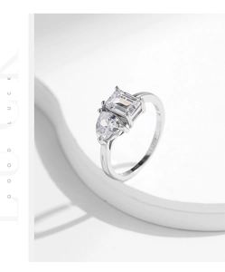 Detail of emerald cut zircon and heart stone on S925 silver ring with 3-prong setting