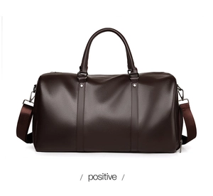 Deep brown leather travel bag detail showing texture, silver hardware and shoulder strap