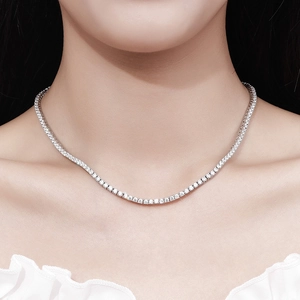 2.5mm moissanite tennis necklace in 925 sterling silver worn on a woman's neck