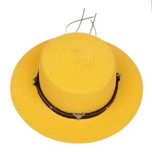 Detail of yellow straw hat with leather band, metal studs, and silver bull head decor