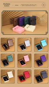 Detail of luxury textured paper jewelry gift boxes with gold bow accents in multiple colors