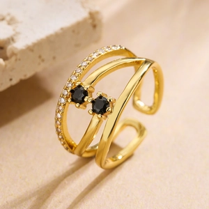 Detail of gold multilayer open ring featuring black cubic zirconia and paved accents