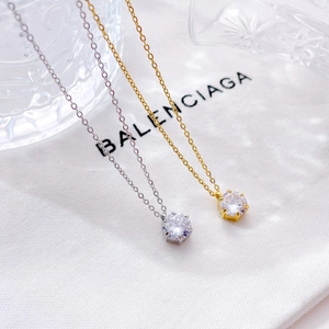 Minimalist six-prong solitaire pendant necklace in silver and gold with sparkling round stone