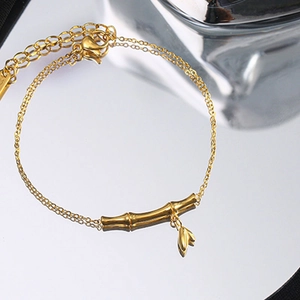 Elegant 18k gold plated stainless steel bamboo link bracelet with leaf charm on mirror