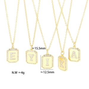 Detail of gold letter pendants E Y I K A with pavé crystals and size measurements