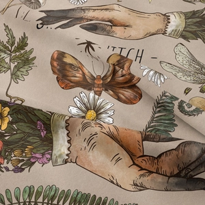 Detailed macro view of vintage witch tapestry fabric texture with hand and moth patterns