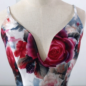 Detail of the plunging V-neckline on the floral satin evening dress with rose print