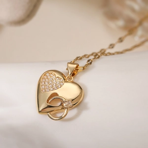 Close-up of 18K gold plated heart pendant necklace with zircon inlay and double ring links