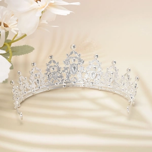 Close-up of silver luxury crown with rhinestones and hollow floral patterns for weddings