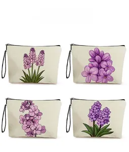 Detailed pattern display of four floral canvas makeup bags with purple flower prints