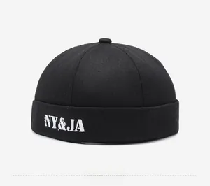Detail view of black docker hat showing white NY&JA embroidery and twill cotton fabric texture