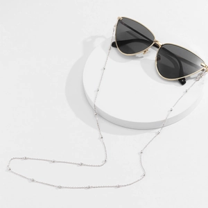 Silver metal glasses chain with small beads on minimalist cat-eye sunglasses