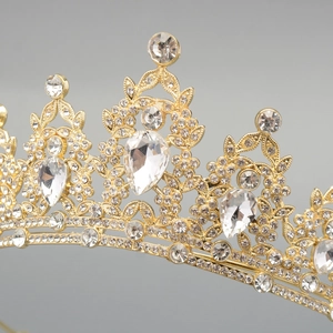 Luxurious gold crystal tiara for women featuring teardrop rhinestones and floral patterns