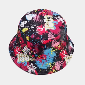 Detail shot of street style bucket hat featuring vibrant graffiti prints and cool text