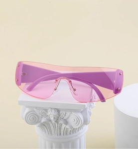 Detail of pink Y2K oversized rimless sunglasses on a white decorative pedestal