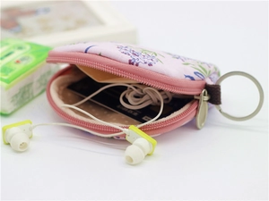 Pink floral fabric coin purse showing internal storage for earphones and credit cards